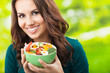 Young woman with salad, outdoors