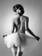A young and sexy naked ballet dancer in white clothes