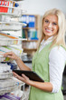 Young Blond Pharmacist Using Digital Tablet