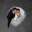 Young hispanic wedding couple on black background