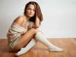 Young woman sitting on  floor