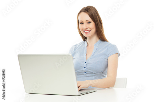 Photo: Young woman working on laptop Young woman working on laptop