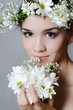 Portrait of the beautiful girl with flowers in hair