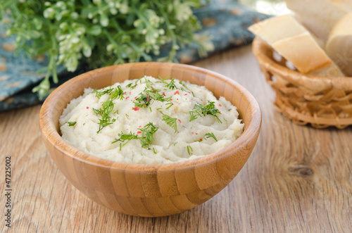 Photo: Mashed potatoes and cabbage in a bowl on a wooden table Mashed potatoes and cabbage in a bowl on a wooden table