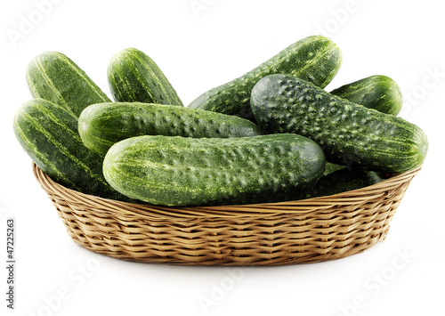 Photo: cucumbers in basket isolated cucumbers in basket isolated