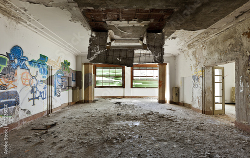 Photo: abandoned building, large room, debris on the floor abandoned building, large room, debris on the floor