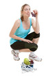 Photo: Sporty young woman with scales and fruits. healthy lifestyle Sporty young woman with scales and fruits. healthy lifestyle