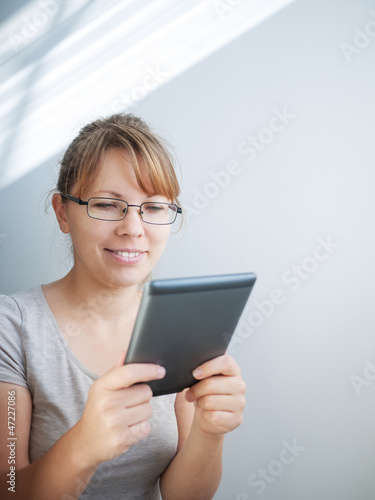 Photo: young woman using tablet PC young woman using tablet PC