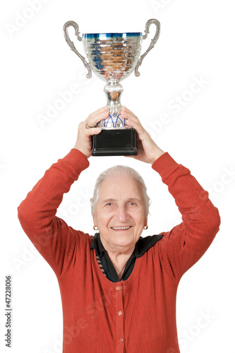 Photo: isolated old lady raising trophy on white background isolated old lady raising trophy on white background