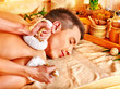 Man getting herbal ball massage treatments .