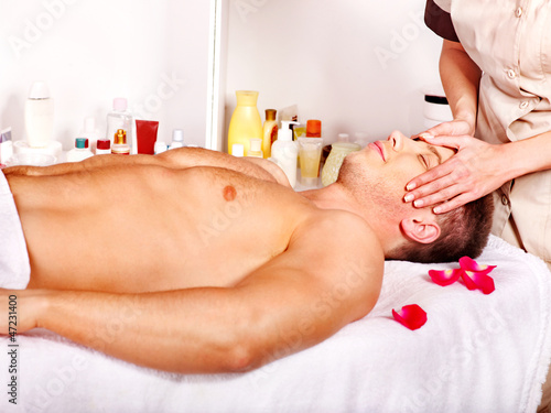 Photo: Man getting facial massage . Man getting facial massage .