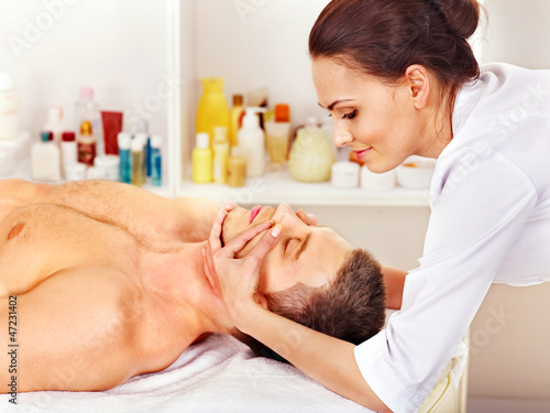 Photo: Man getting facial massage . Man getting facial massage .