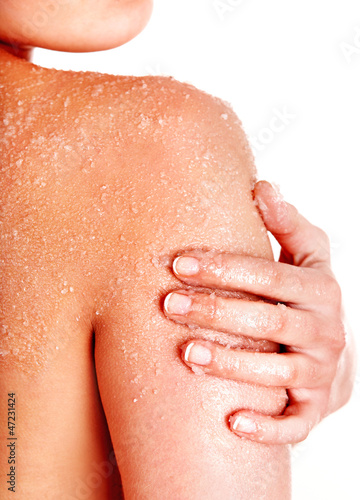 Photo: Beautiful young woman scrubbing body. Beautiful young woman scrubbing body.