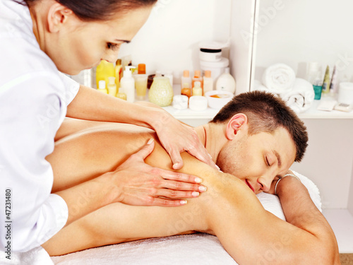Photo: Man getting massage in spa. Man getting massage in spa.