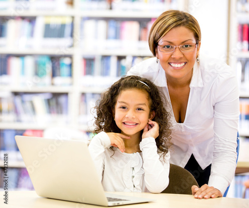 Photo: Girl with a computers teacher Girl with a computers teacher