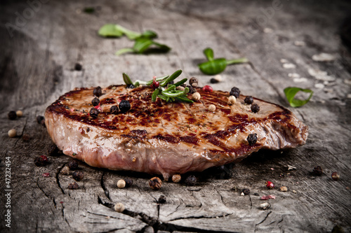 Photo: Delicious beef steak on wood Delicious beef steak on wood