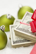 Photo: Stack of Hundred Dollar Bills with Bow Near Christmas Ornaments Stack of Hundred Dollar Bills with Bow Near Christmas Ornaments