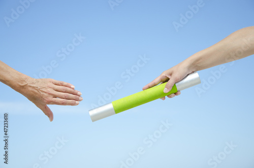 Photo: Isolated athletes hands with baton Isolated athletes hands with baton