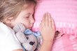 beautiful girl sleeps on pink sheets