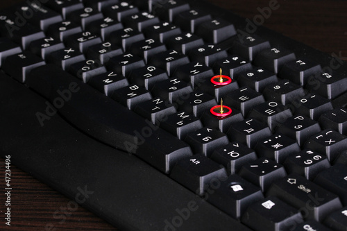 Photo: Painful typing, pins on keyboard close-up Painful typing, pins on keyboard close-up