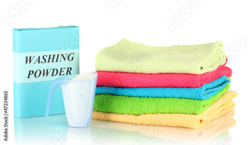 Photo: Box of washing powder with blue measuring cup and towels, Box of washing powder with blue measuring cup and towels,