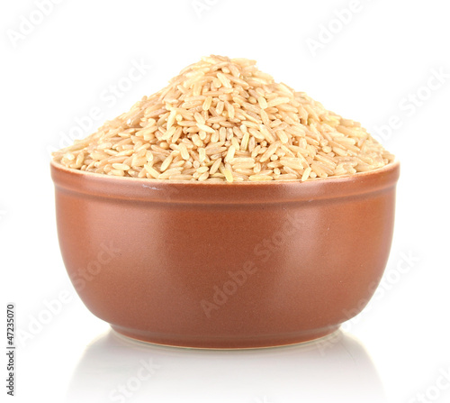 Photo: brown rice in a brown plate , isolated on white brown rice in a brown plate , isolated on white