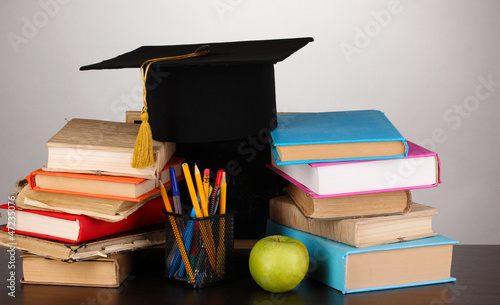 Photo: Books and magister cap against school board Books and magister cap against school board