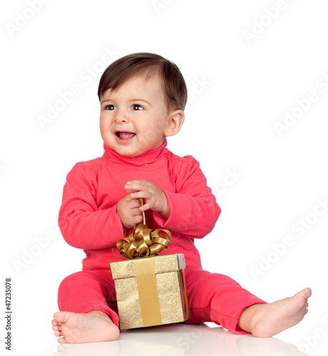 Photo: Adorable baby playing with a present Adorable baby playing with a present