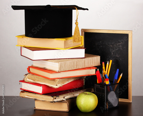 Photo: Books and magister cap against school board Books and magister cap against school board