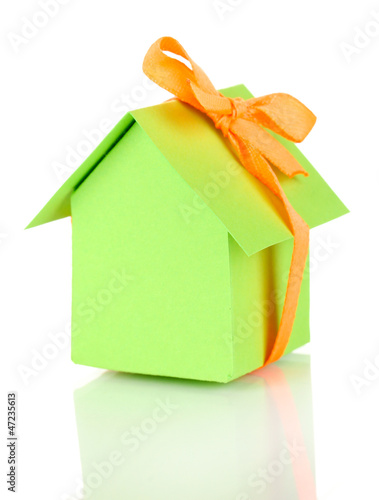 Photo: Small house with ribbon isolated on white Small house with ribbon isolated on white
