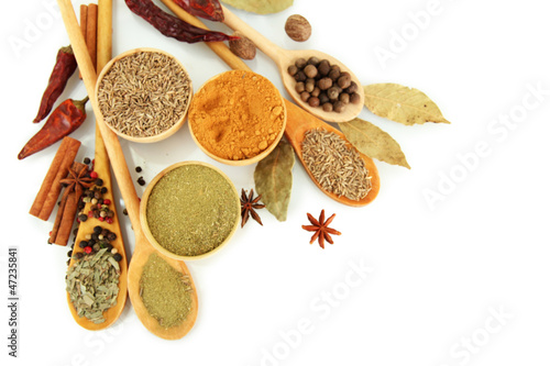 Photo: wooden bowls and spoons with spices, isolated on white wooden bowls and spoons with spices, isolated on white
