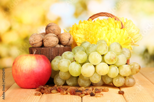 Photo: Grape with nuts on wooden table Grape with nuts on wooden table