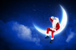 photo of santa claus sitting on the moon