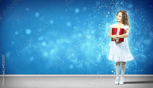 Photo: Happy girl opening gift box Happy girl opening gift box