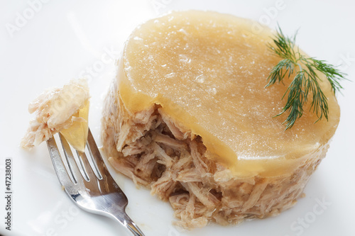 Photo: meat in aspic on white plate closeup meat in aspic on white plate closeup