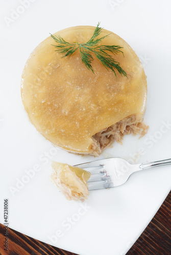 Photo: meat in aspic on white plate closeup meat in aspic on white plate closeup
