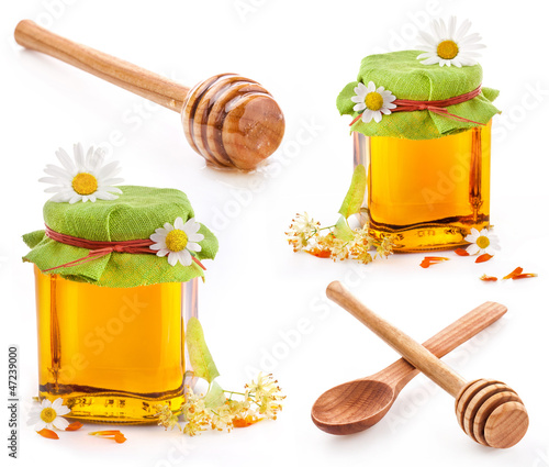 Photo: Honey dipper and Honey in glass jar isolated on white Honey dipper and Honey in glass jar isolated on white