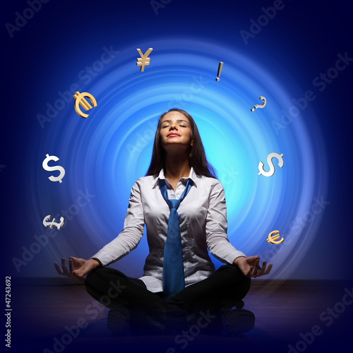 Photo: Business woman with financial symbols around Business woman with financial symbols around