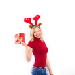 beautiful blonde woman with reindeer antlers is smiling