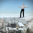 Balancing businesswoman and cityscape