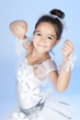 Beautiful little dancer, ballerina in white dress over blue