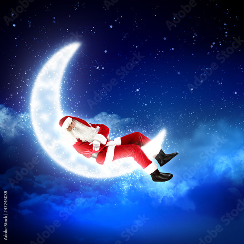 Photo: photo of santa claus sitting on the moon photo of santa claus sitting on the moon