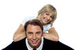 Beautiful wife leaning over her cheerful husband