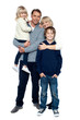 Photo: Affectionate family of four posing in winter outfits Affectionate family of four posing in winter outfits
