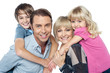 Fun loving family of four. Kids enjoying piggy ride.