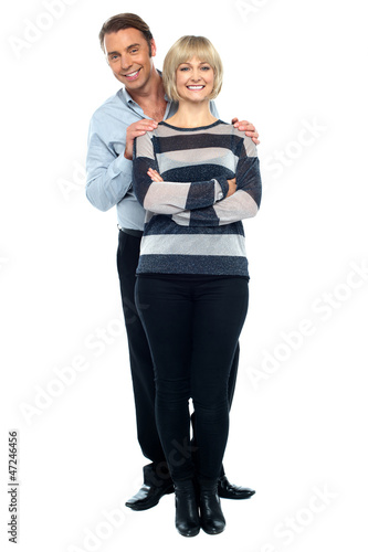Photo: Middle aged husband holding his wife from behind Middle aged husband holding his wife from behind