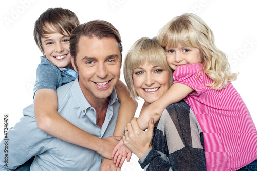 Photo: Fun loving family of four. Kids enjoying piggy ride. Fun loving family of four. Kids enjoying piggy ride.