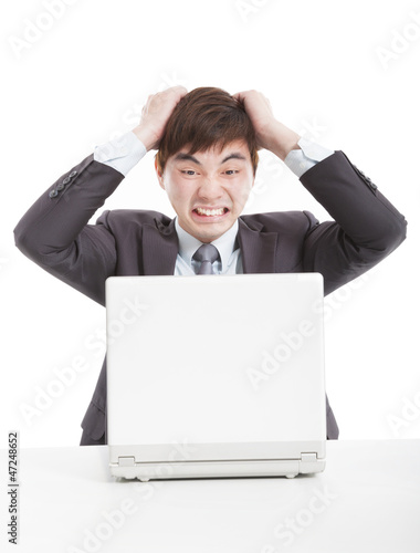 Photo: frustrated businessman with a laptop frustrated businessman with a laptop
