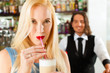 Barista with client in his cafe or coffeeshop