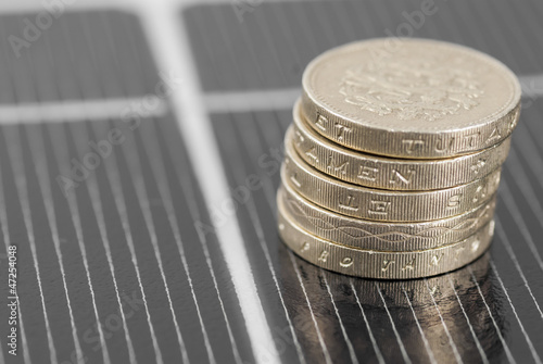 Photo: Macro PV Solar Panel and money. Macro PV Solar Panel and money.